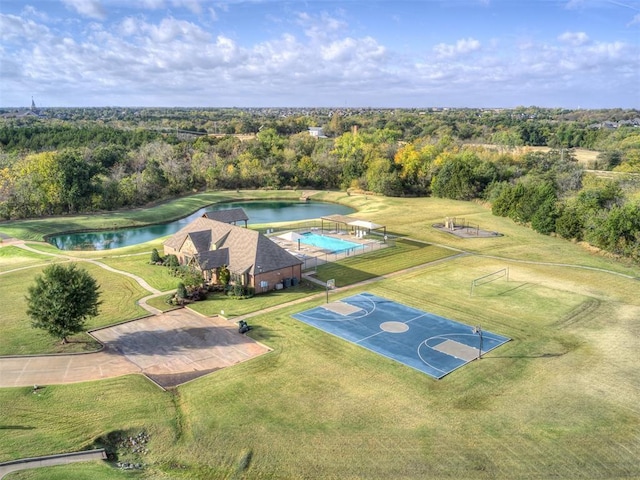 birds eye view of property with a water view and a wooded view