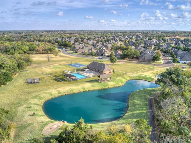 birds eye view of property with a water view and a residential view