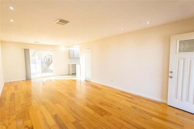 unfurnished living room featuring baseboards, recessed lighting, visible vents, and light wood-style floors