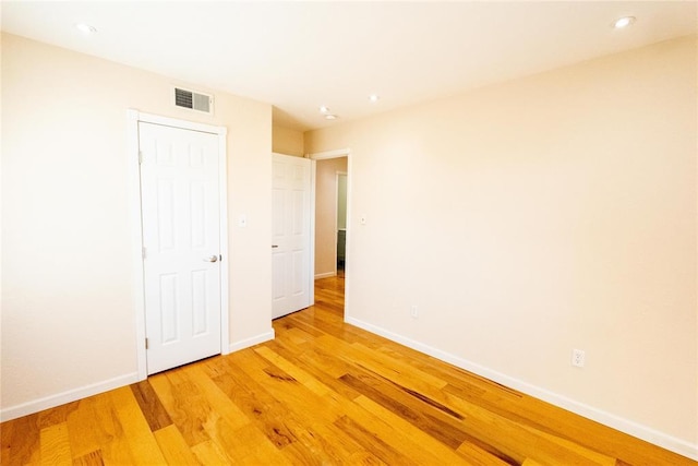 interior space with recessed lighting, baseboards, visible vents, and light wood finished floors