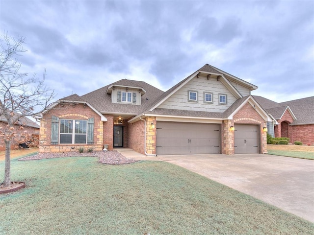 craftsman house featuring driveway, a shingled roof, a front yard, and brick siding