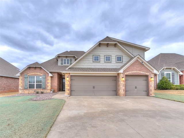 craftsman-style home featuring driveway, stone siding, a shingled roof, and a front lawn