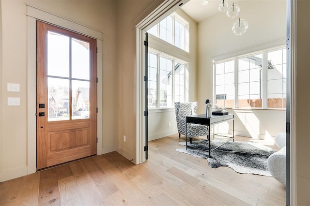 entryway with light wood-style floors and baseboards