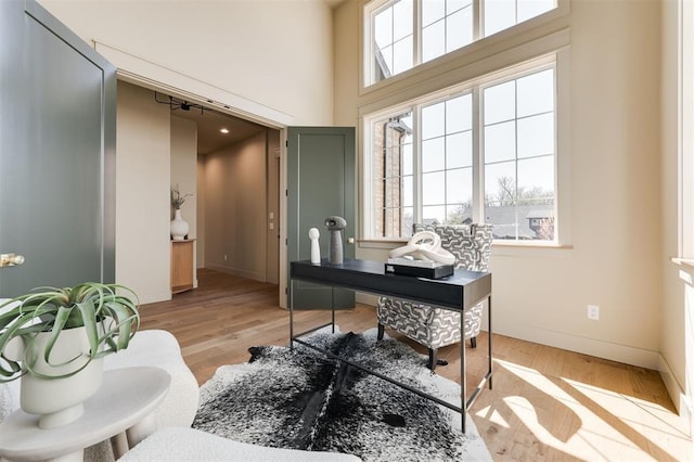 home office featuring light wood finished floors and baseboards