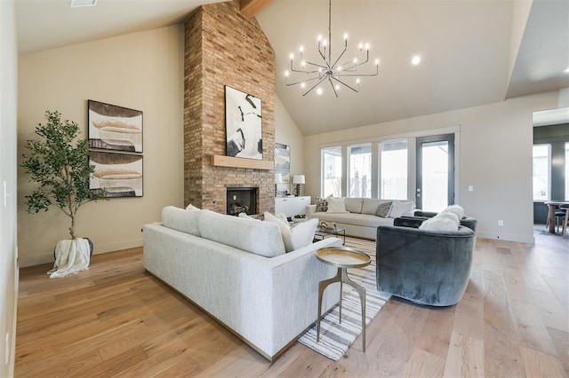 living room with a wealth of natural light, light wood-type flooring, and a brick fireplace