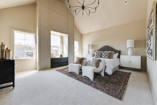 carpeted bedroom with multiple windows, high vaulted ceiling, and a chandelier