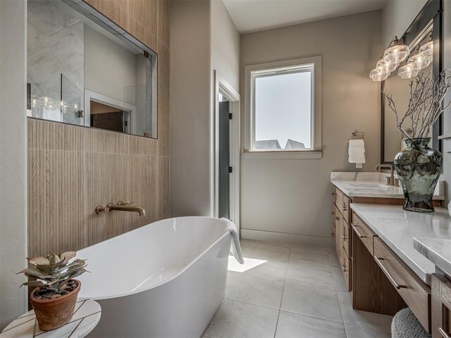 full bathroom featuring tile patterned floors, a freestanding bath, vanity, and a walk in shower