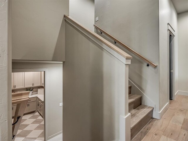 stairway with tile patterned floors