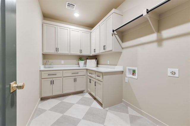 clothes washing area featuring cabinet space, baseboards, visible vents, hookup for a washing machine, and light floors