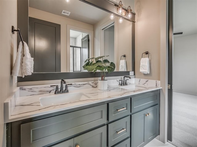 bathroom featuring visible vents, a sink, and double vanity