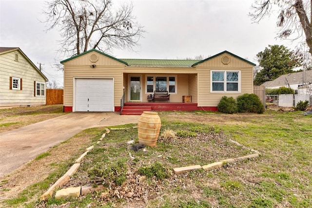 ranch-style home featuring a porch, concrete driveway, an attached garage, fence, and a front lawn