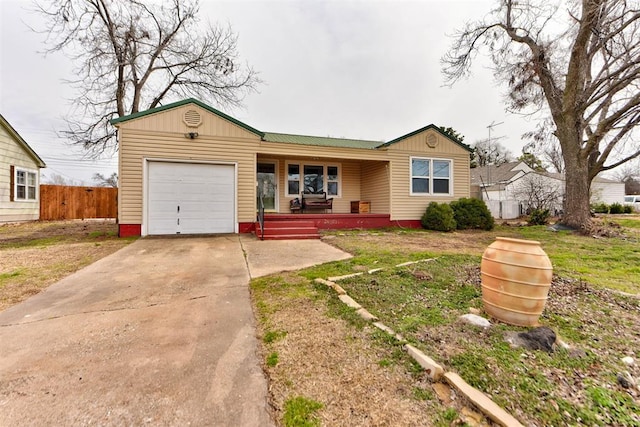 single story home featuring driveway, a porch, an attached garage, and fence