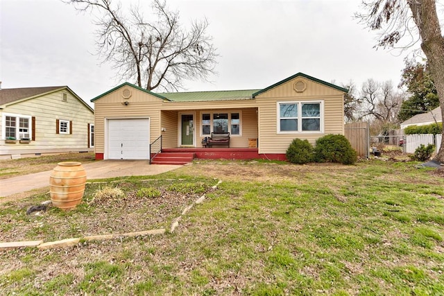 ranch-style home featuring covered porch, a garage, fence, concrete driveway, and a front yard