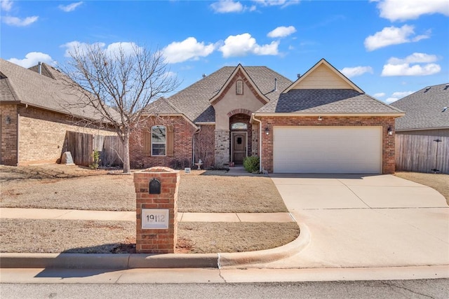 19112 Pinehurst Trail Dr, Edmond, OK 73012 - french country inspired facade with a garage, roof with shingles, concrete driveway, and brick siding
