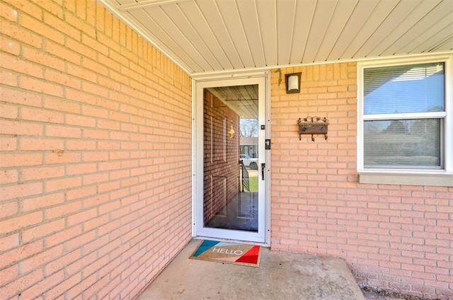 property entrance with brick siding