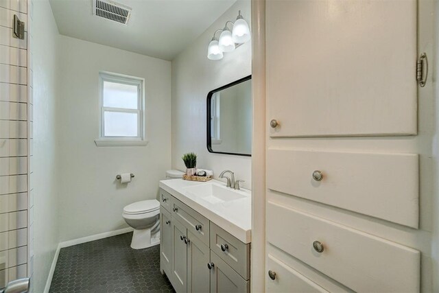 full bathroom with toilet, baseboards, visible vents, and vanity