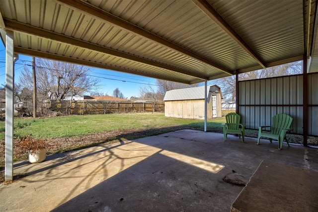 view of patio with a storage shed, an outbuilding, and a fenced backyard