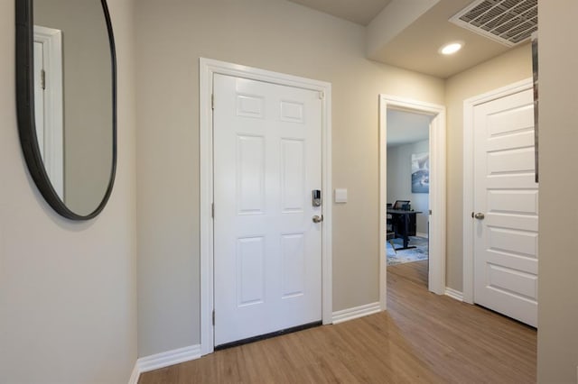 entryway with light wood-type flooring, visible vents, baseboards, and recessed lighting