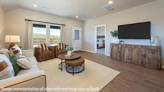 living room with recessed lighting, visible vents, vaulted ceiling, and wood finished floors