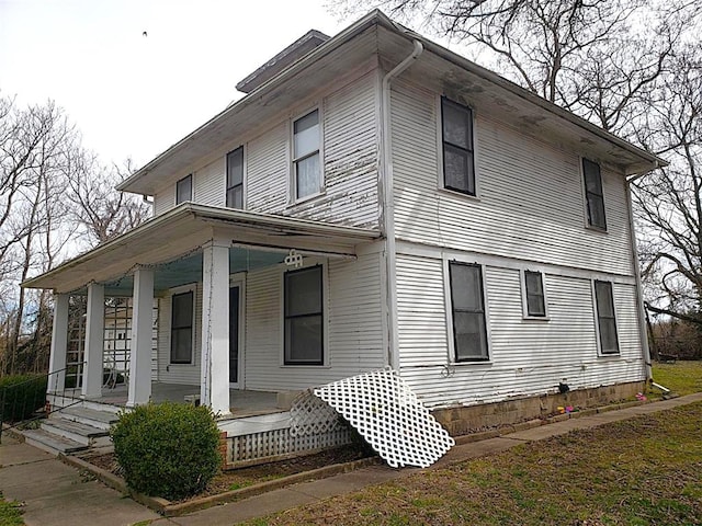 view of side of property with covered porch