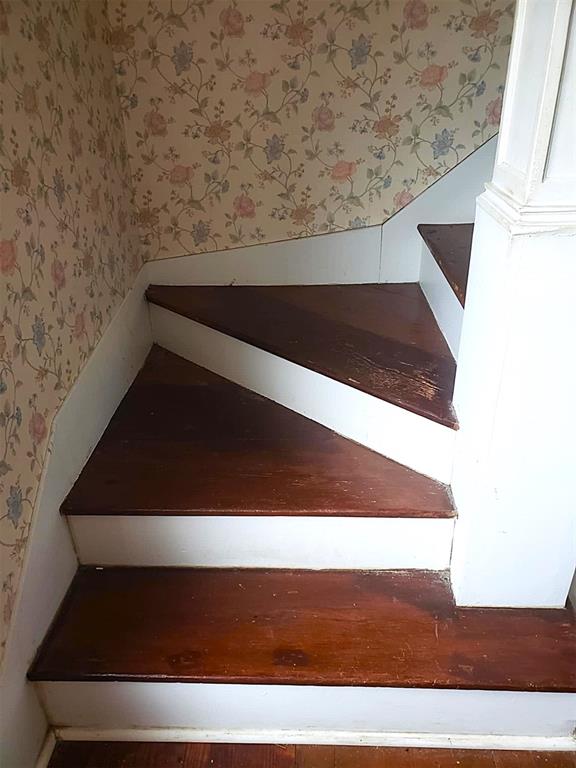 stairway with wallpapered walls