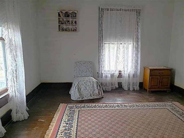 sitting room with wood-type flooring and baseboards