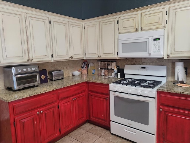 kitchen featuring light stone countertops, white appliances, a toaster, and light tile patterned floors