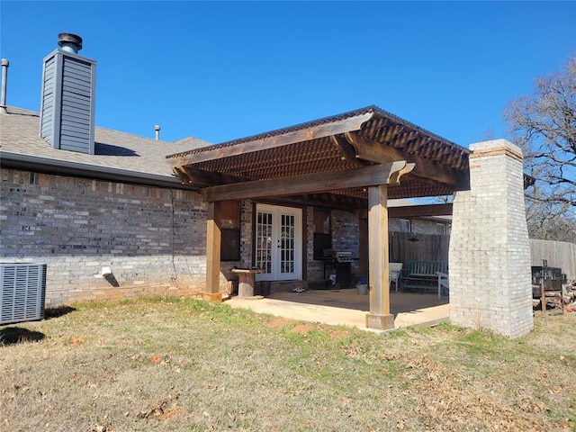 rear view of house with french doors, a shingled roof, a patio area, fence, and a pergola