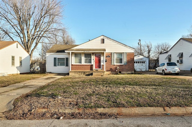 bungalow-style home with a garage, brick siding, and a front lawn