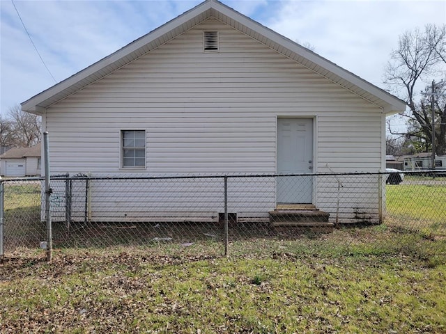 view of property exterior with fence and a lawn