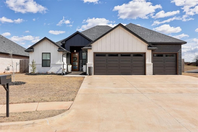 modern farmhouse style home featuring a garage, concrete driveway, board and batten siding, and roof with shingles