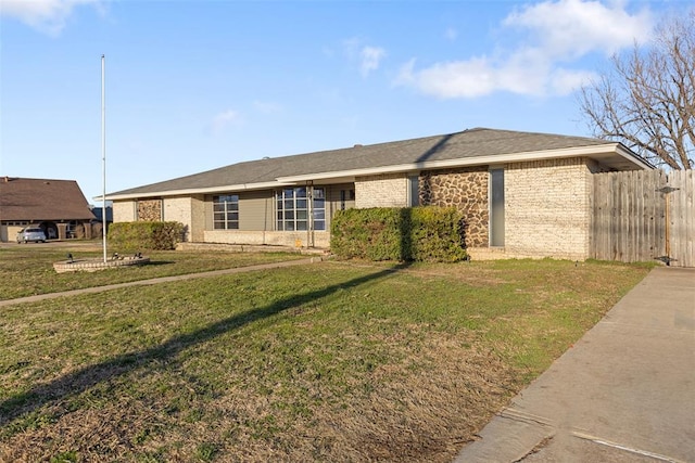 ranch-style house with brick siding, a front yard, and fence