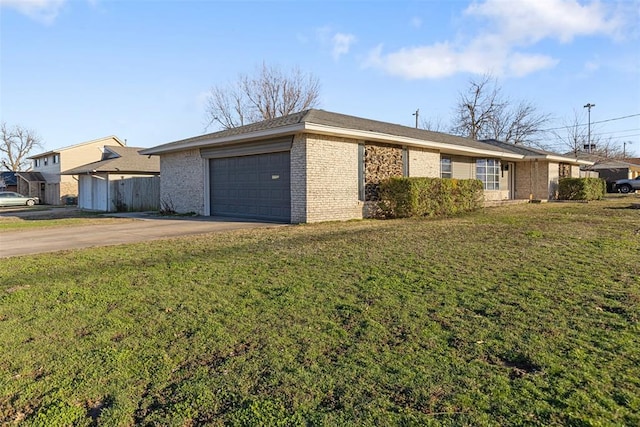 view of front of house with a garage, concrete driveway, a front lawn, and brick siding