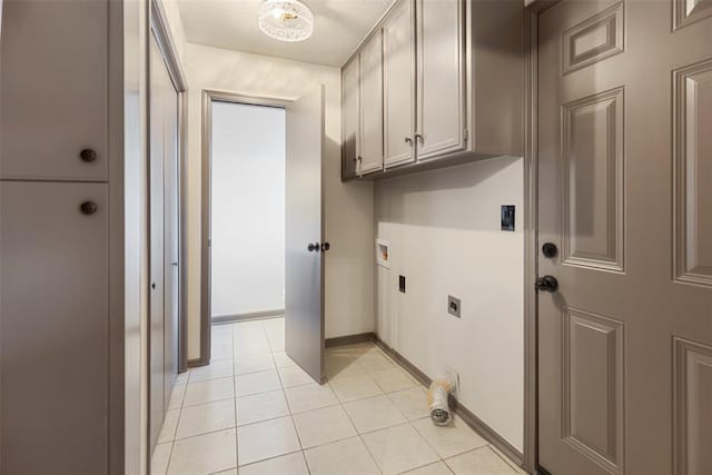 clothes washing area featuring washer hookup, light tile patterned floors, cabinet space, electric dryer hookup, and baseboards