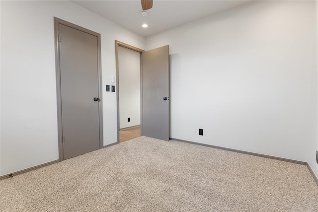 unfurnished bedroom with baseboards, recessed lighting, a ceiling fan, and light colored carpet