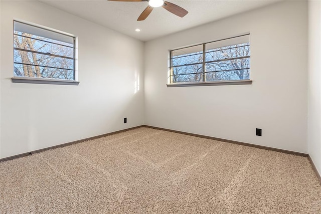 carpeted empty room with ceiling fan, baseboards, a wealth of natural light, and recessed lighting