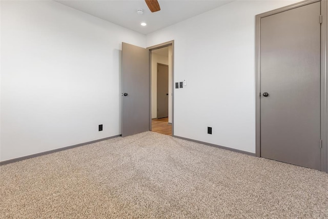 unfurnished bedroom featuring recessed lighting, light carpet, ceiling fan, and baseboards