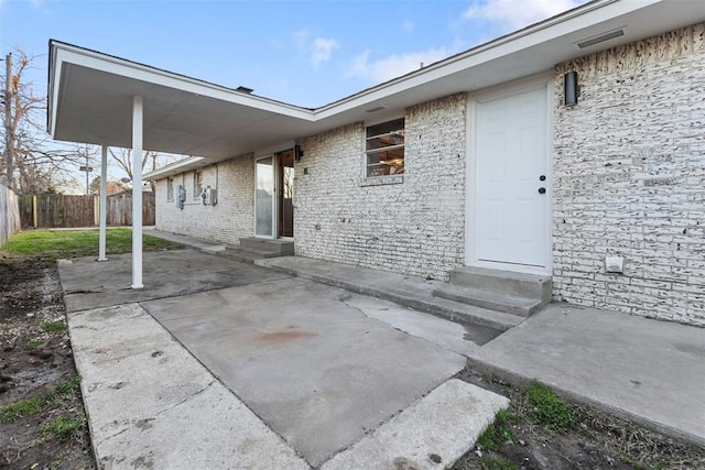 view of patio with entry steps and fence