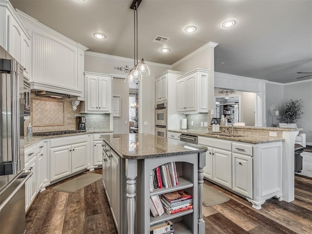 kitchen with crown molding, visible vents, appliances with stainless steel finishes, white cabinetry, and a sink