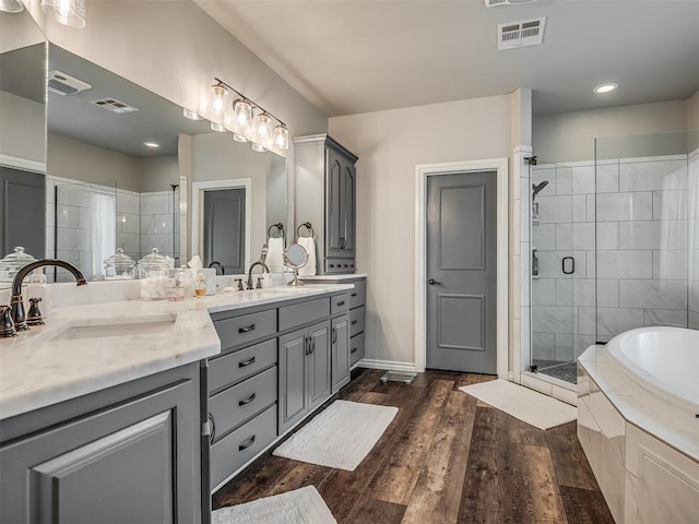 full bathroom featuring a stall shower, visible vents, and a sink