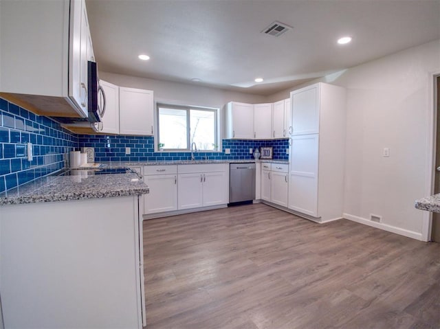 kitchen with light wood-style floors, visible vents, appliances with stainless steel finishes, and light stone counters