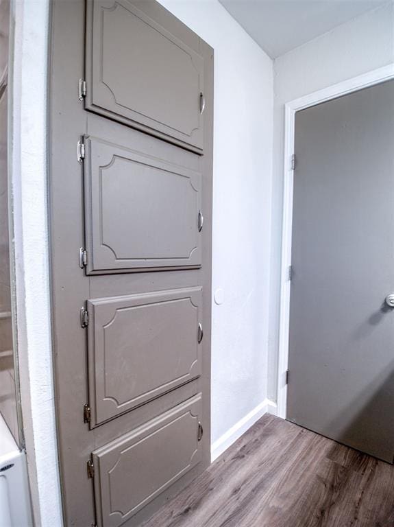 interior space with wood finished floors and baseboards