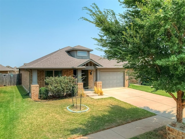 view of front of home with an attached garage, brick siding, fence, driveway, and a front yard