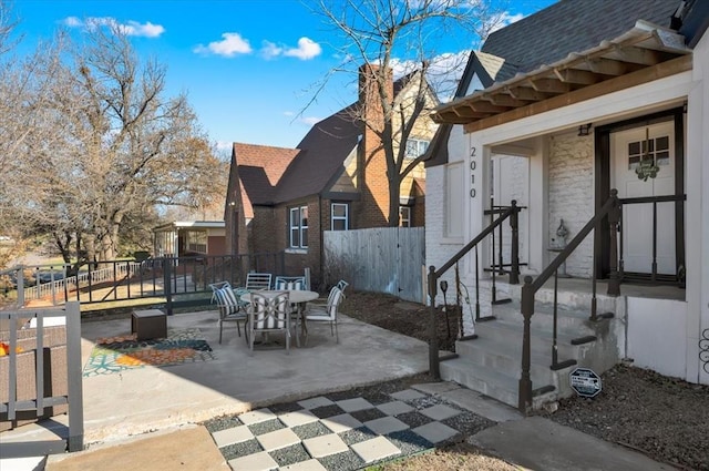 view of patio / terrace featuring outdoor dining area and fence