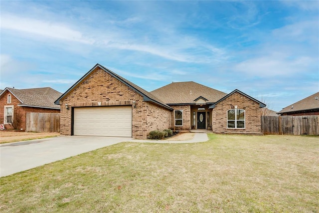 view of front of home with a garage, concrete driveway, brick siding, and fence