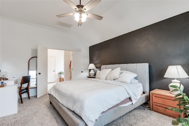 bedroom featuring ceiling fan, lofted ceiling, visible vents, and light colored carpet