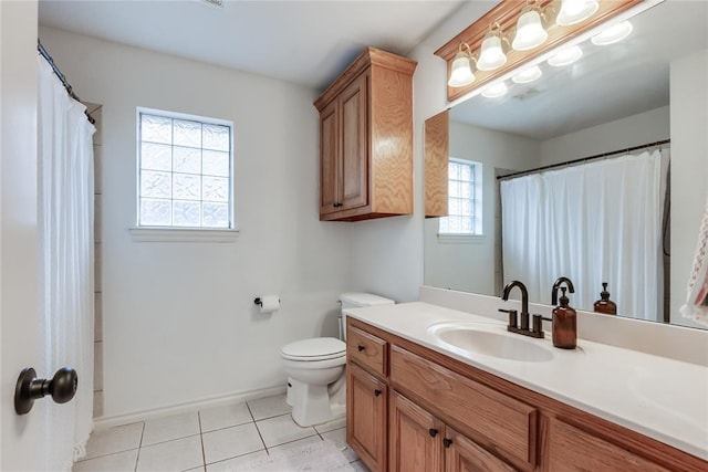 bathroom with toilet, tile patterned flooring, baseboards, and vanity