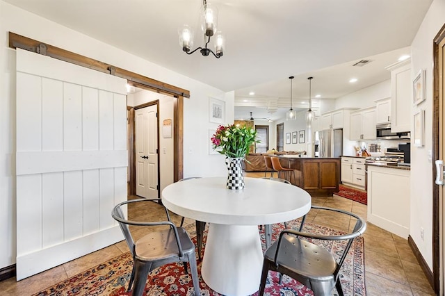 dining space with visible vents, recessed lighting, a barn door, light tile patterned floors, and a chandelier