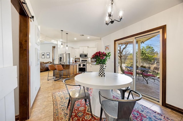 dining room with a notable chandelier, recessed lighting, baseboards, and a barn door