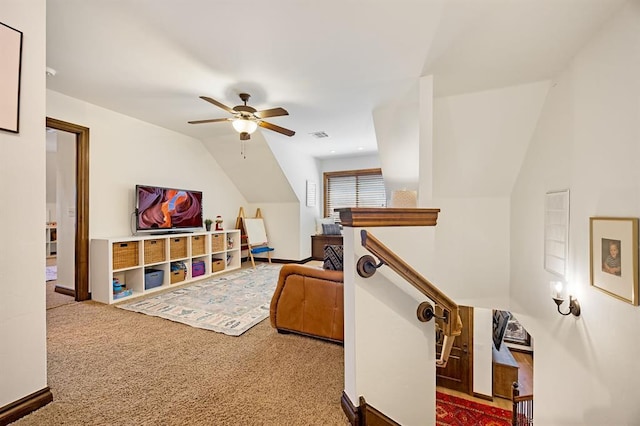 interior space featuring carpet, ceiling fan, and vaulted ceiling